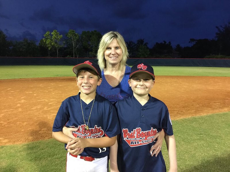 Cole, who had Car T-cell therapy, poses with his brother and mom. 