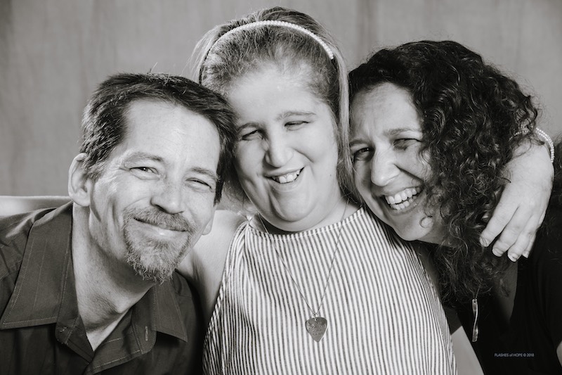 Jillian, who has a rare disease, poses with her parents