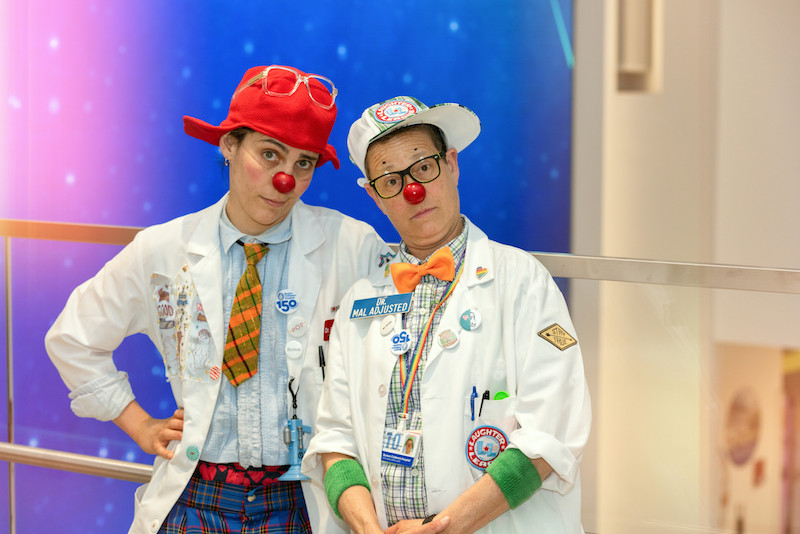 Two of the clowns from the Laughter League pose in the hospital