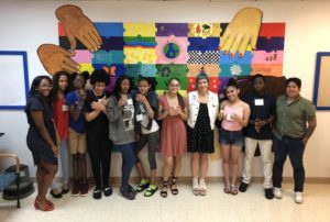 Kids pose in front of their mural
