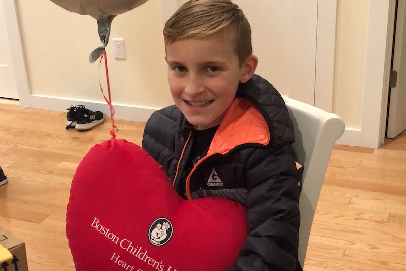 Nicholas, who had a double-switch procedure for CCTGA, holds a heart pillow.