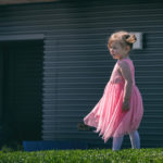 little girl with cdh wears a pink dress