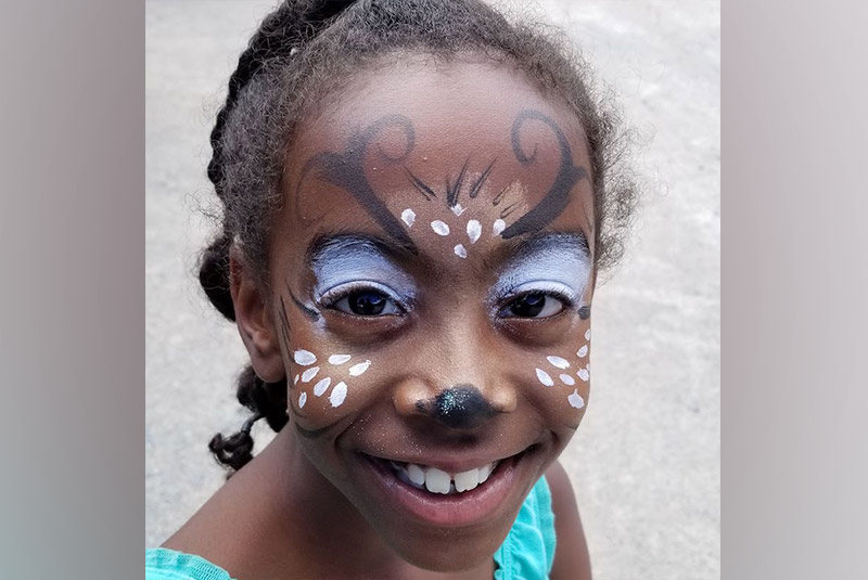 Jasmine, who had surgery for a Pott's puffy tumor, with her face painted like a deer.