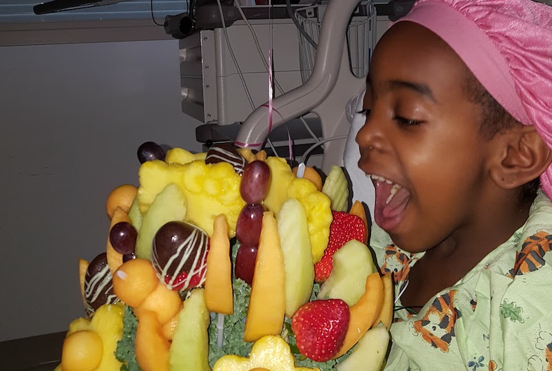 Jasmine, who had surgery for a Pott's puffy tumor, receives a fruit bouquet after her surgery.