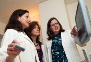 Dr. Valente discusses a case with colleagues