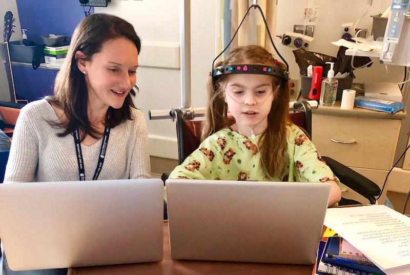Lexi, who had complex spine surgery, works on her writing with writer-in-residence