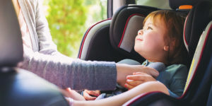 Toddler girl buckled into her car seat