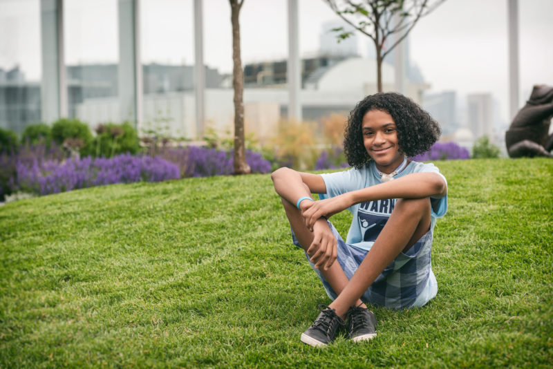 boy with esophageal damage sits on grass