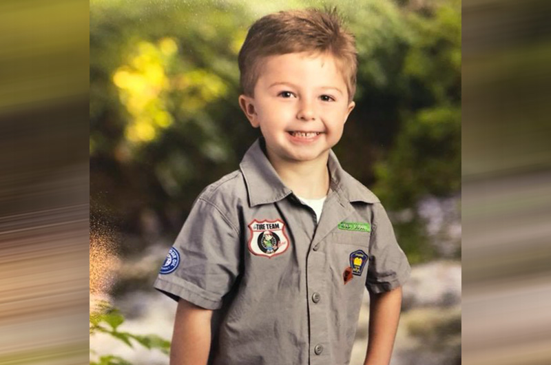 boy with esophageal atresia wearing a scout uniform