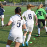 Female soccer players during agility training, which could reduce the risk of concussion.