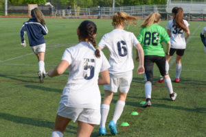Female soccer players during agility training, which could reduce the risk of concussion.