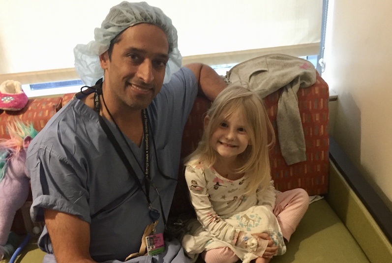 Elyse, who had a biventricular repair for heterotaxy, poses with her cardiac surgeon
