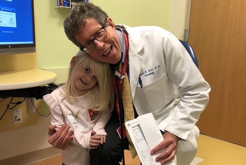 Elyse, who had a biventricular repair for heterotaxy, poses with her cardiologist
