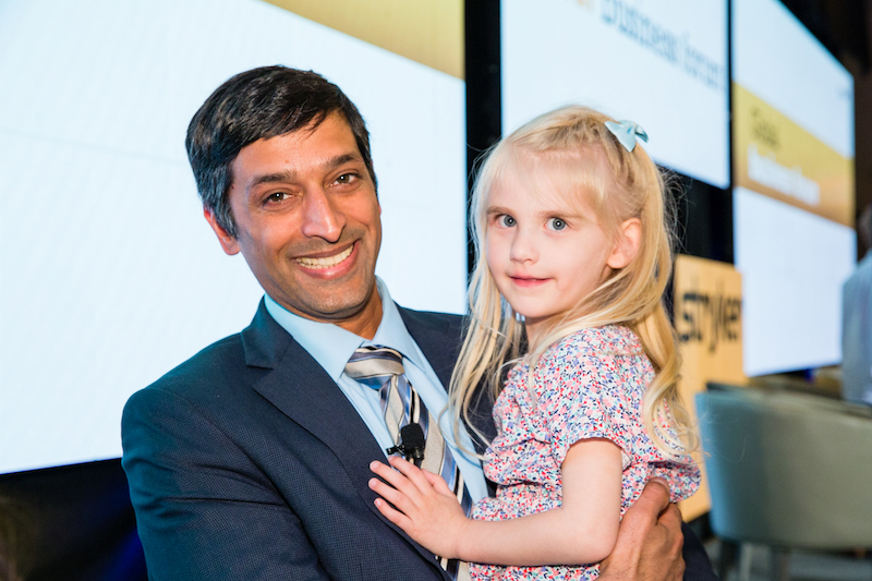 Elyse, who had a biventricular repair for heterotaxy, poses with her cardiac surgeon at a conference.