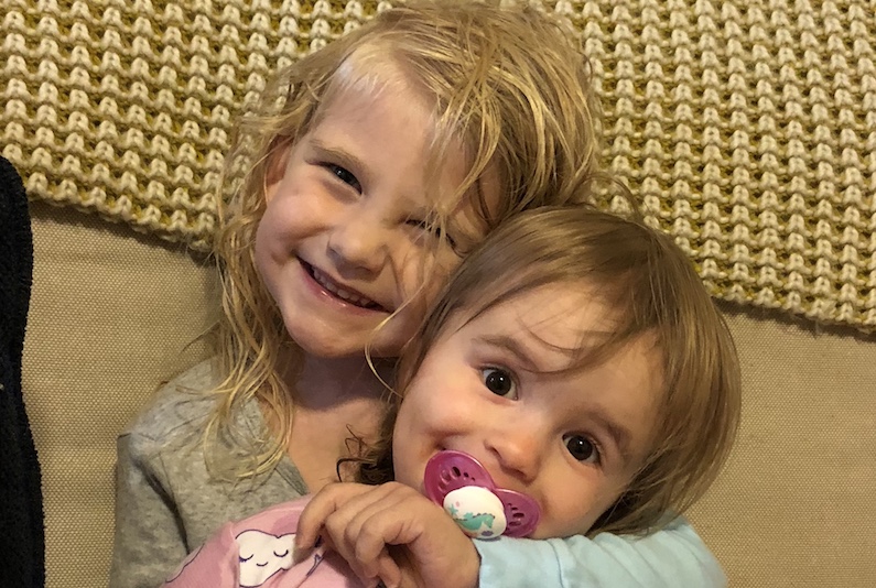 Elyse, who had a biventricular repair for heterotaxy, poses with her sister, Kayla