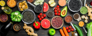 Vegan foods: Fresh vegetables and spices with legumes a wooden background