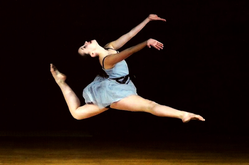 Photo of Alana, who had hip dysplasia, leaping through the air as a young dancer. 