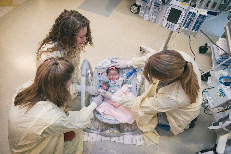 Caregivers around child in the CICU