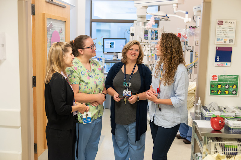 Members of the care team discuss a patient's care plan