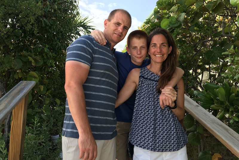 Gavin, who has Crohn's disease, poses outdoors with his family. 