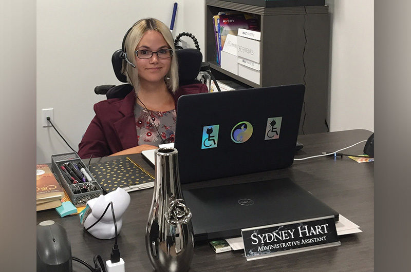 sydney sits at her desk after being treated for pain