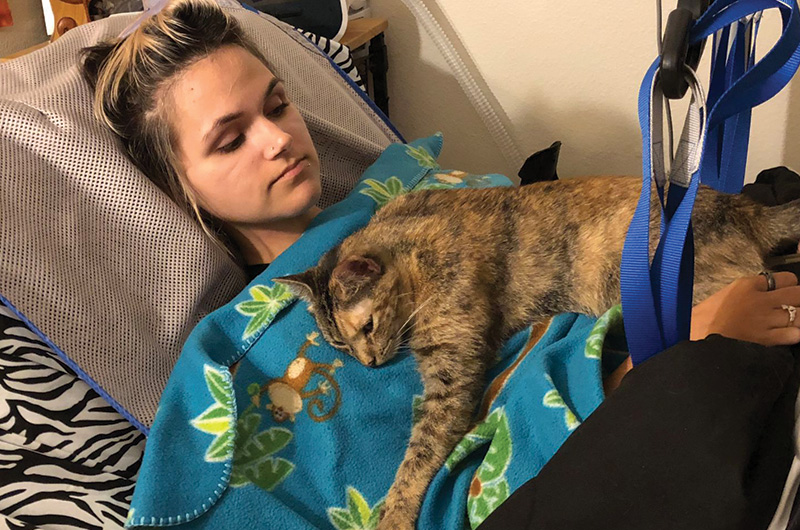 pain patient in bed with her cat