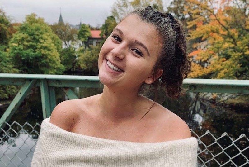 Maddie, who had treatment for Ewing sarcoma, poses outside her college