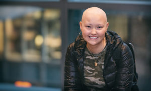 Darcey, who has Li-Fraumeni syndrome, poses in front of the hospital