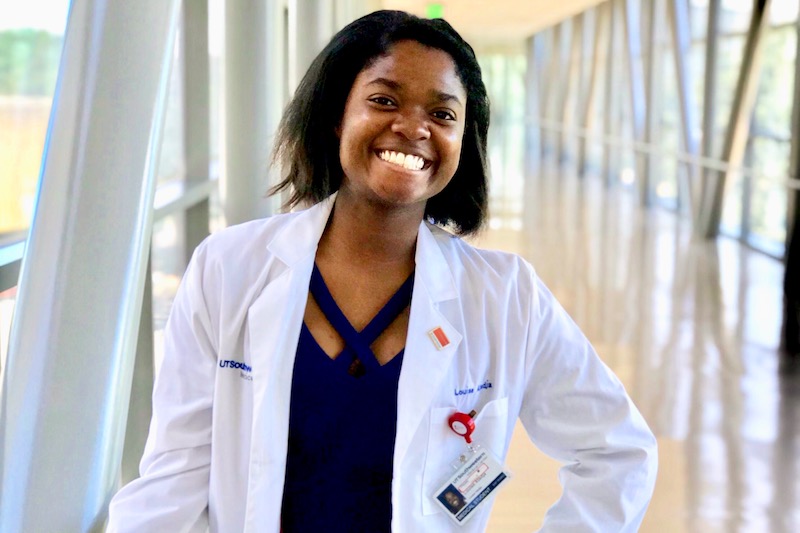 Louise, who had hip surgery, poses in her white jacket.