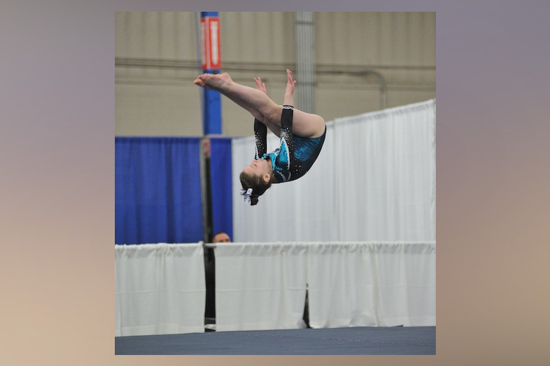 Mikayla, who was treated for hip avulsion fracture, mid-air during a backward flip.