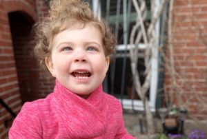 Ellery, who has OMS, plays outside