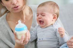 Baby crying, while mom tries to soothe
