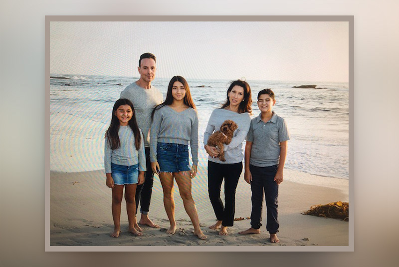 Max, who has SDS, at the beach with his mom, dad, two sisters, and dog