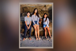 Max, who has Shwachman Diamond syndrome, poses outdoors with his two sisters