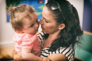 Sophie, who has SMA type 1, gets a hug from her mom