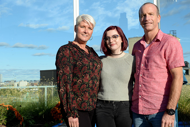 girl with chronic pain poses with her parents