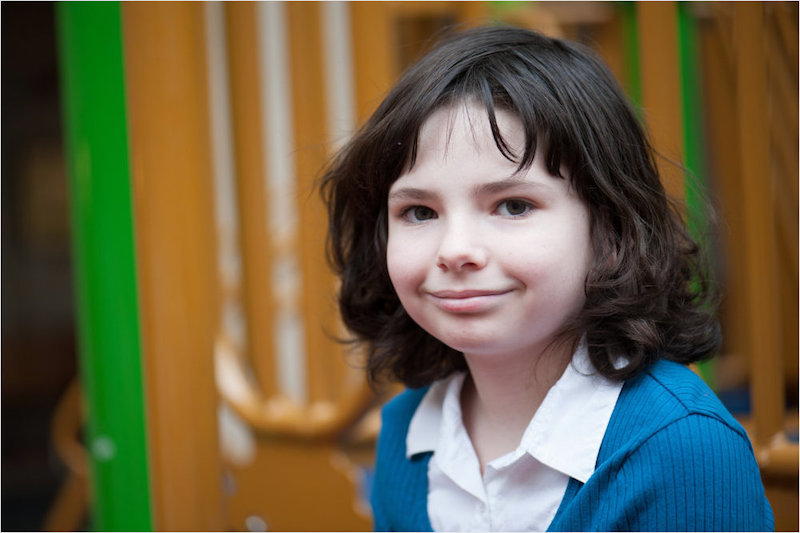 Samantha sits on the playground after being bullied