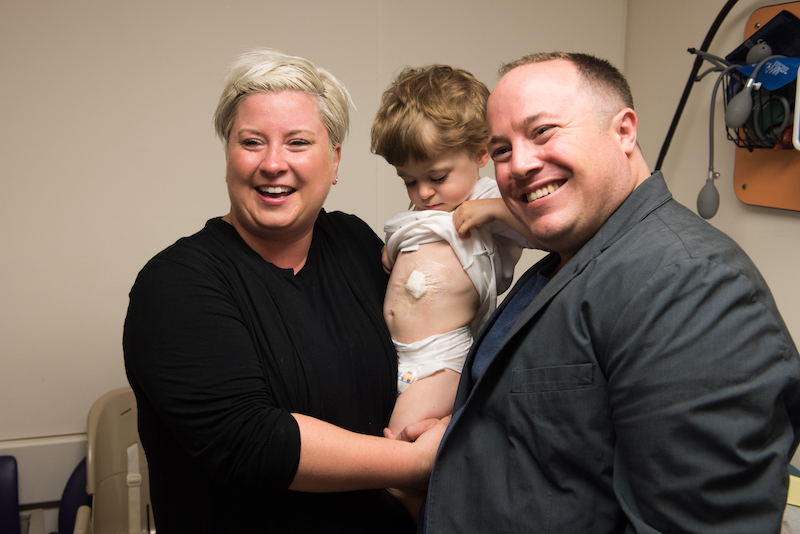 jack and his parents smile after having his G-tube removed