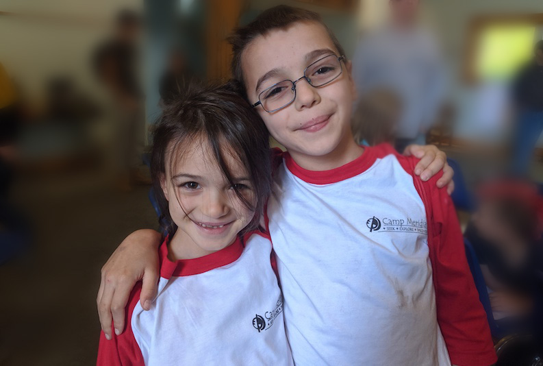 Luca, who has congenital heart disease, with his younger sister at a camp for kids with heart conditions