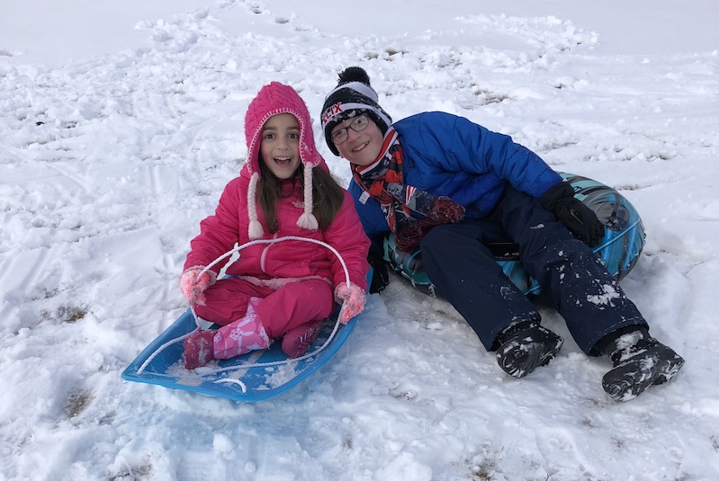 Mary, who has a type of genetic epilepsy, sleds with her brother
