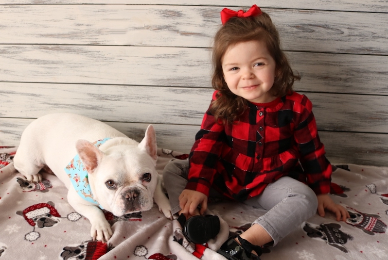 Amelia, who had surgery for epilepsy, poses with her French bulldog