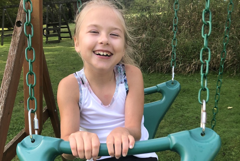 Zeeva, who has a rare type of epilepsy, rides on a swing