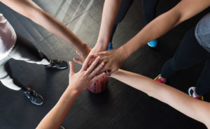 Image of female athletes in pre-game huddle
