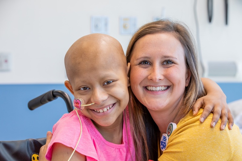 Andrea Lerude, child life specialist, poses with a patient