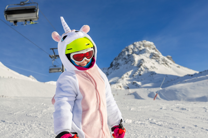 A child dressed as a unicorn on the ski slopes
