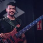 Bruno, who had cubital tunnel syndrome, holds his bass guitar