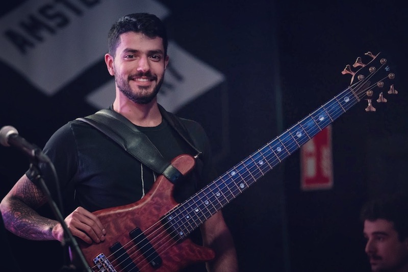 Bruno, who had cubital tunnel syndrome, holds his bass guitar