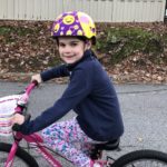 Jane, who had acute flaccid myelitis, on her bike.