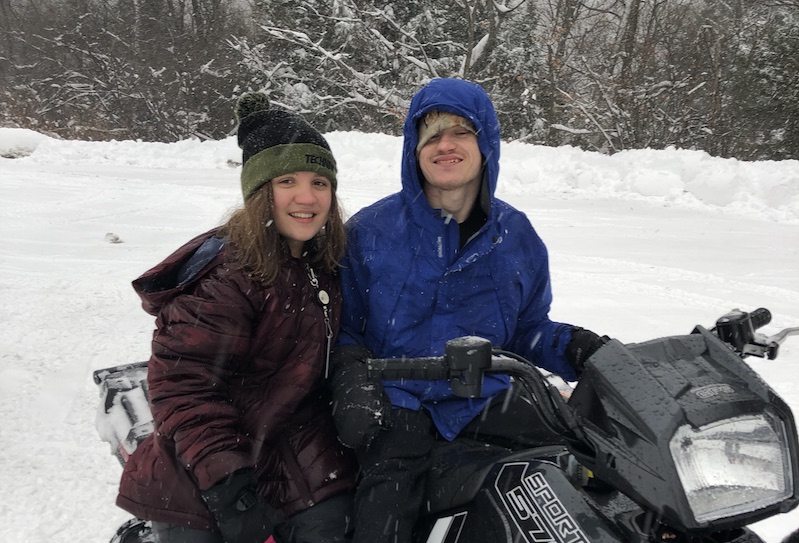 Maria and her cousin about to embark on a snowmobile ride. 