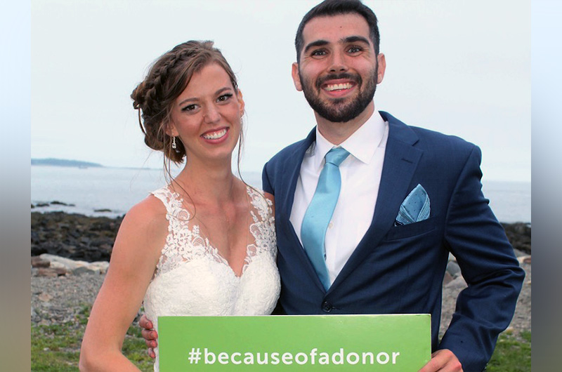Erin, who had a heart transplant, poses with her new husband at the beach